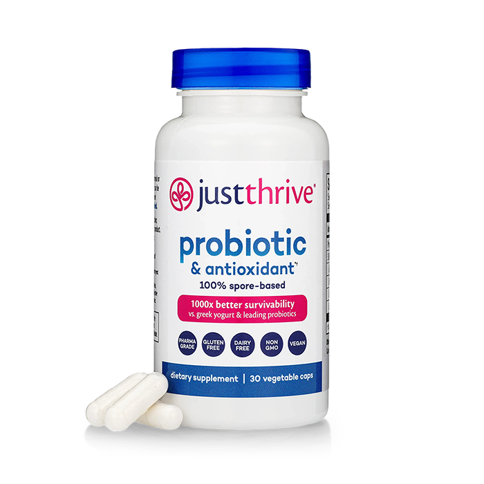 A bottle of Just Thrive Probiotic with two capsules