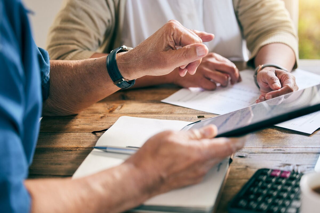 People reviewing paperwork at a table
