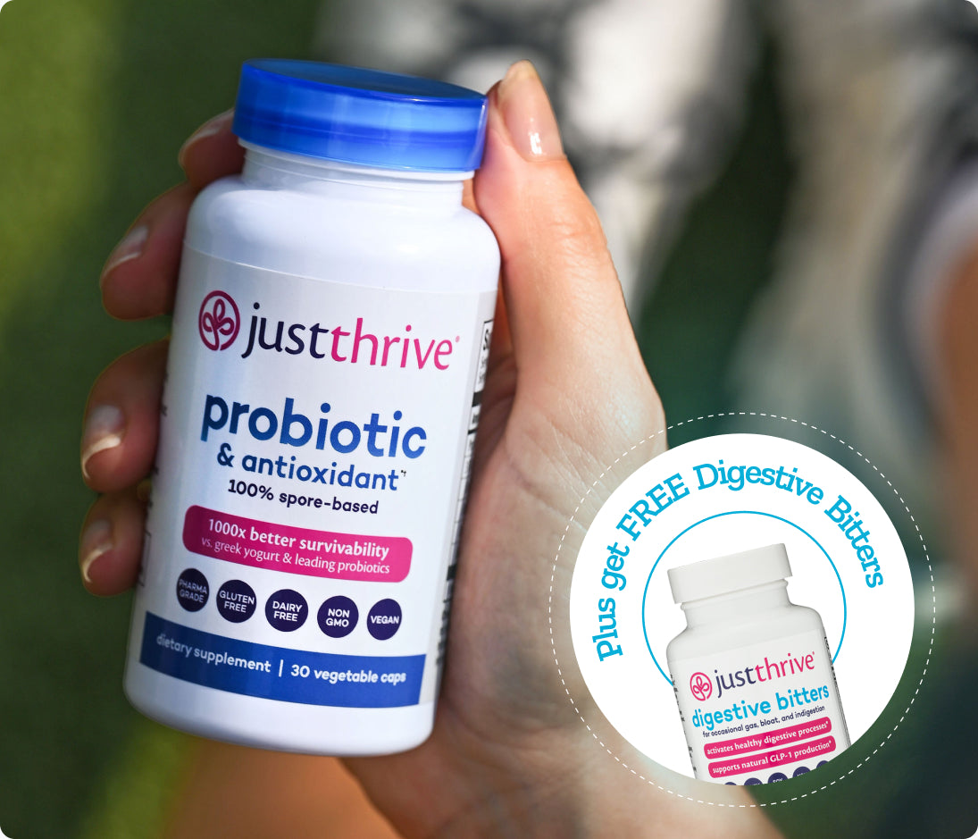 Just Thrive Probiotic bottle in hand, plus free Just Thrive Digestive Bitters