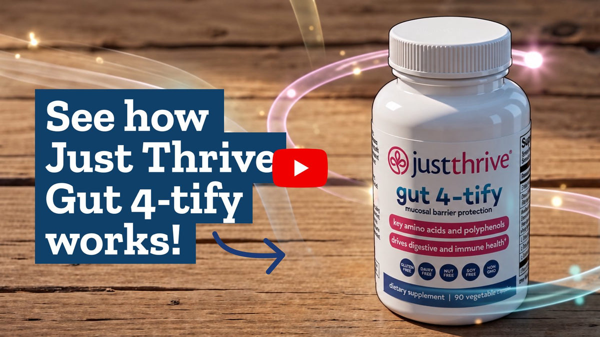 A bottle of Just Thrive Gut 4-tify on a wooden surface
