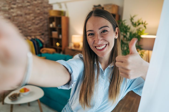 A woman smiling at a table after a meal