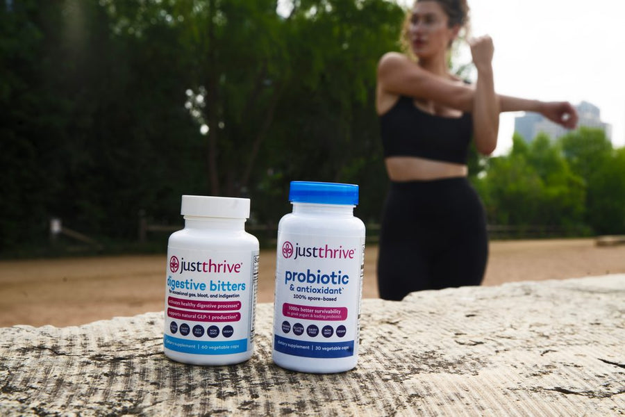 A woman exercising outdoors with Just Thrive Probiotic and Digestive Bitters on a mat